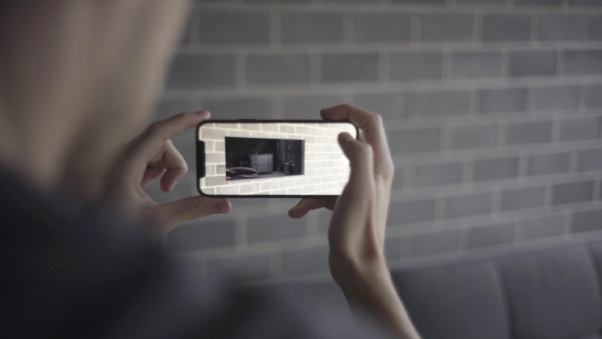 overshoulder of person holding a phone with a AR application